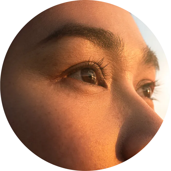 Close-up portrait of a person gazing upward in warm natural light